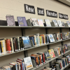 The image shows a display in a library featuring shelves labeled "New and Narrative Non-Fiction." 