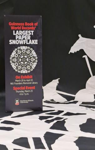 Sign with large paper snowflakes