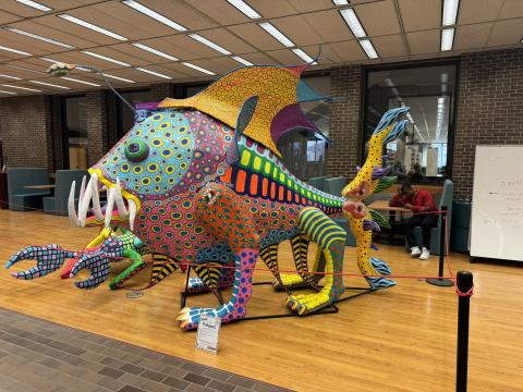 An alebrije sculpture in the library.