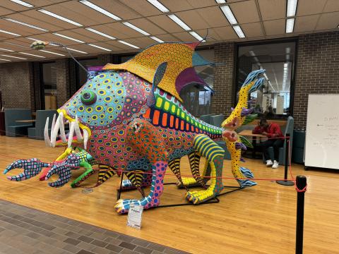 An alebrije sculpture in the library.